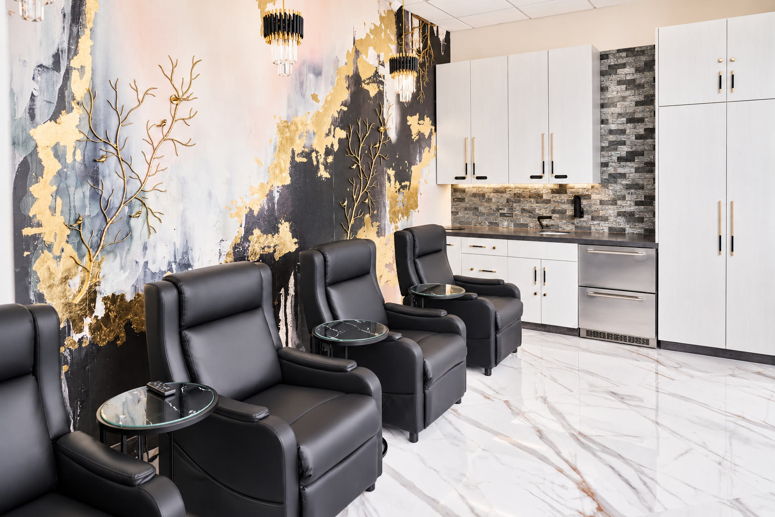 IV lounge with black leather recliners and a gold abstract mural