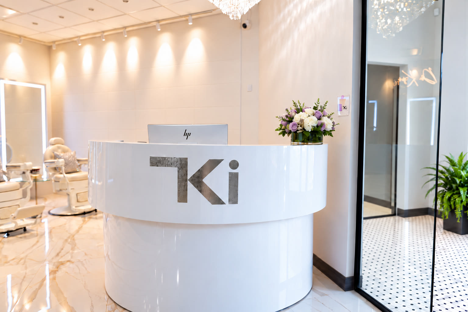White TKI reception desk with fresh flowers