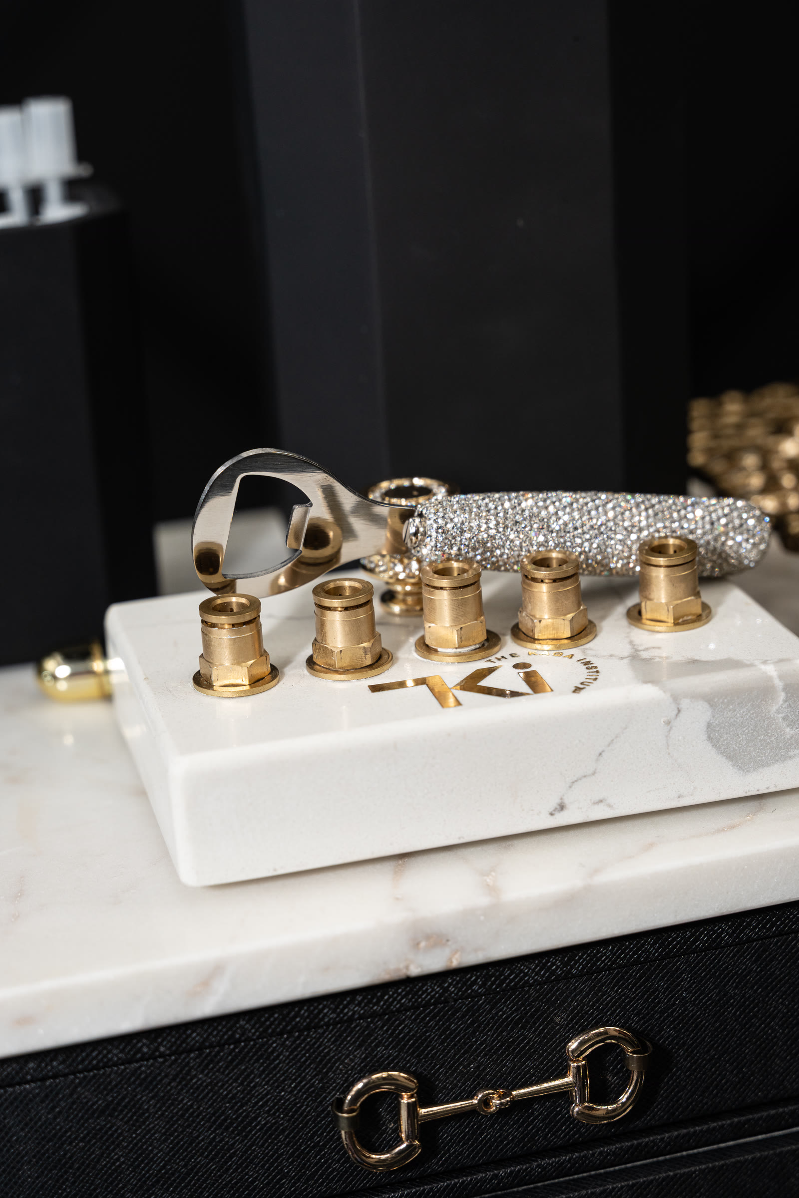 Gold and crystal details on a white marble counter