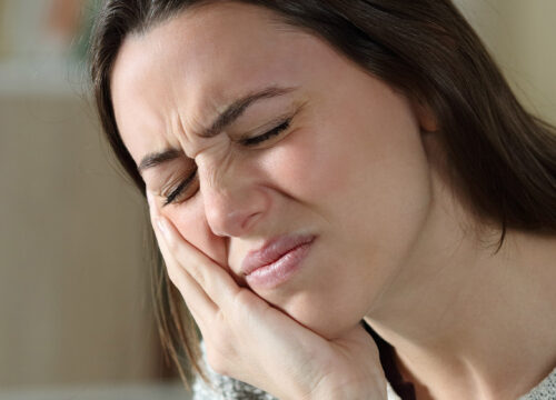 Photo of a woman dealing with pain from TMJ