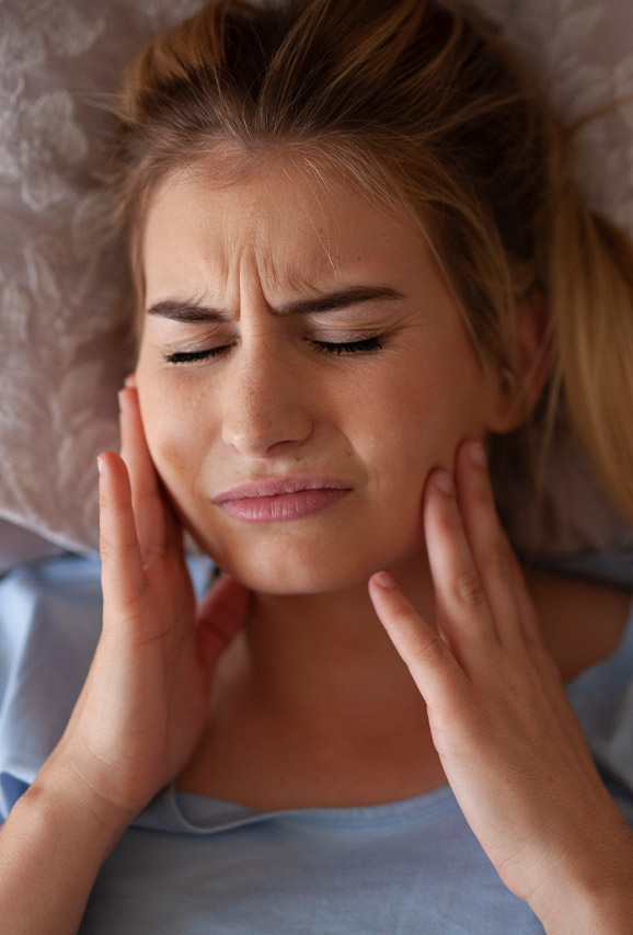 Photo of a woman dealing from the pain of TMJ