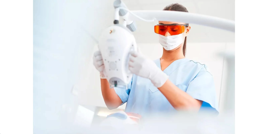 Photo of a dentist using the Zoom! whitening device