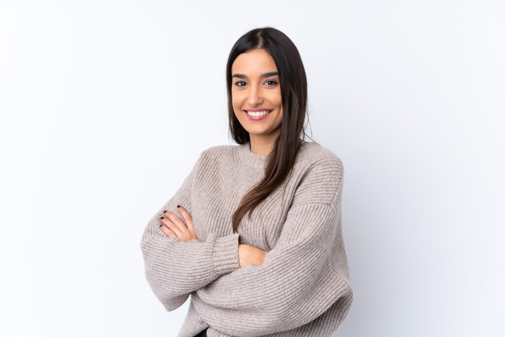 Photo of a smiling woman wearing a sweater