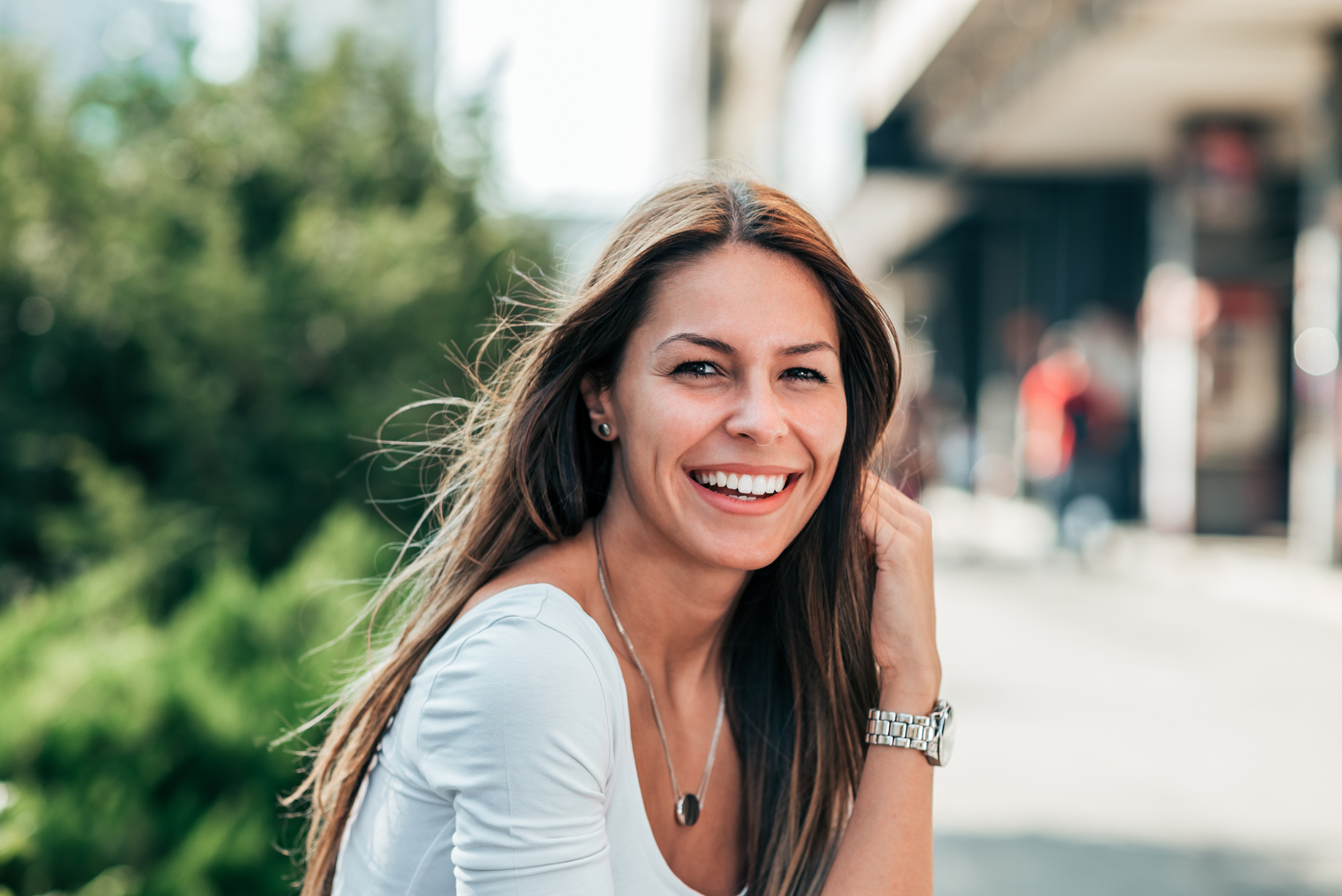 Photo of a woman sitting outside, smiling