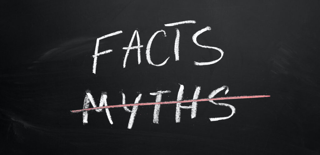 Photo of Facts and Myths written in chalk on a chalkboard with myths crossed out with red chalk