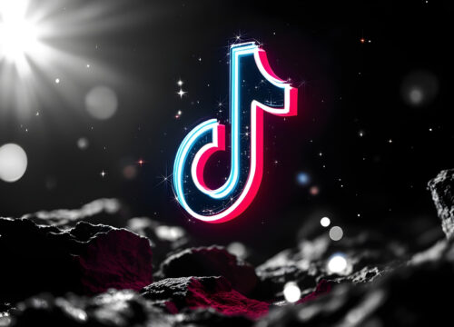 Image of the TikTok logo against a black, shiny background