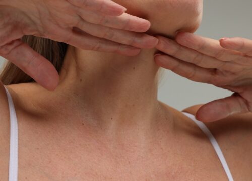 Photo of a middle-age woman's neck, hands, and chest